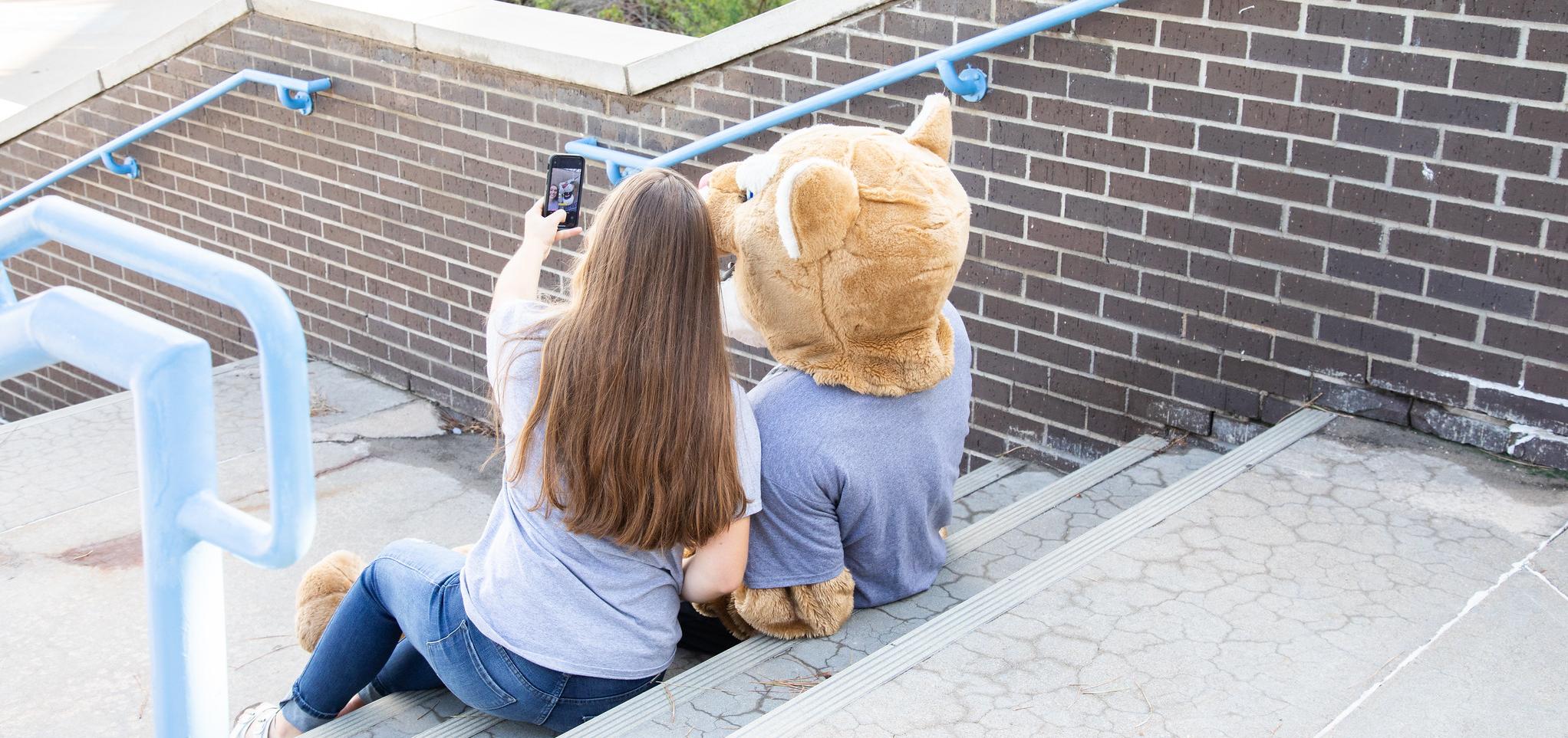 Bart takes a selfie with a student